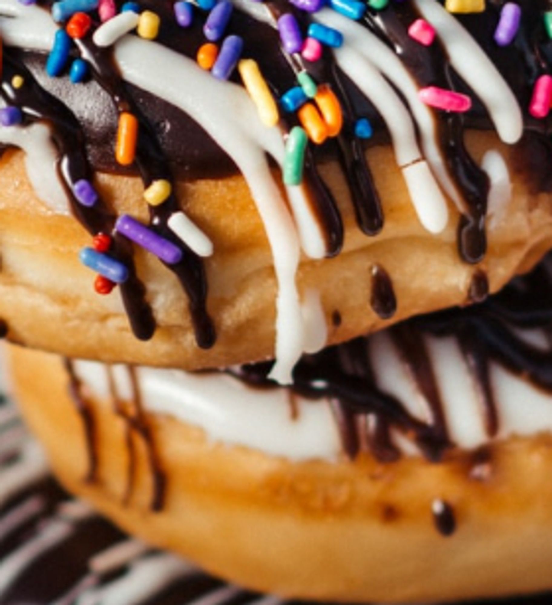 Chocolate covered doughnuts with icing and sprinkles