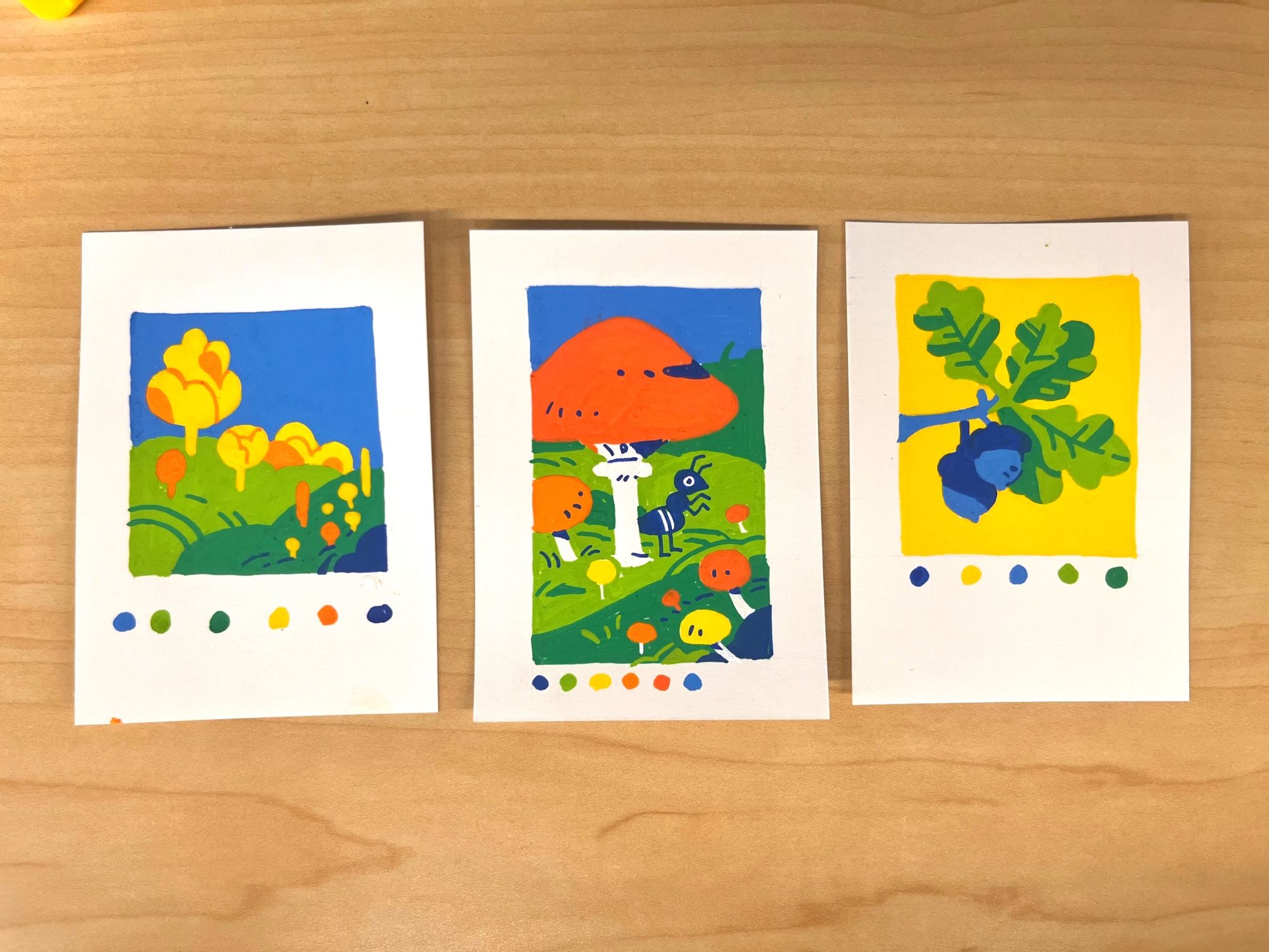 Three trading card size paint pen illustrations: first is a landscape with yellow and orange trees, second is an ant standing under a mushroom, and third is an oak branch with acorns.