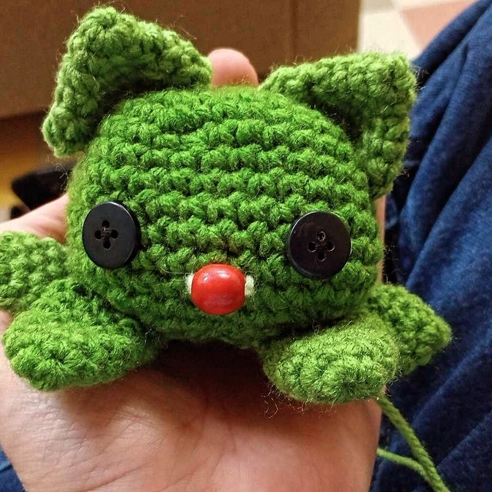 Green crocheted is kitten.