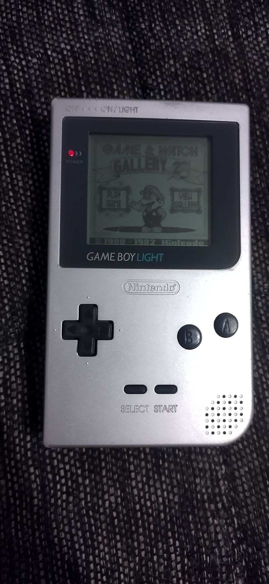 Game Boy Light, with the back-light off, showing the title screen for Game and Watch Gallery 2