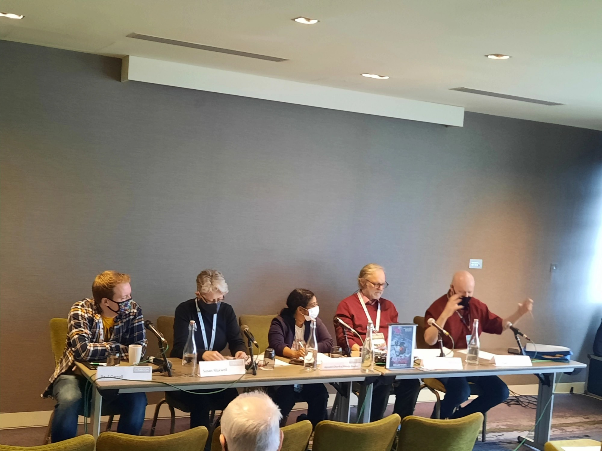 Sitting at a long table are Paul Carroll, Susan Maxwell, Jeevani Charika/Rhoda Baxtor, Richard Sparx, and Michael Carroll. The Relationship Between the Writer and the Reader - Who Owns the Text?