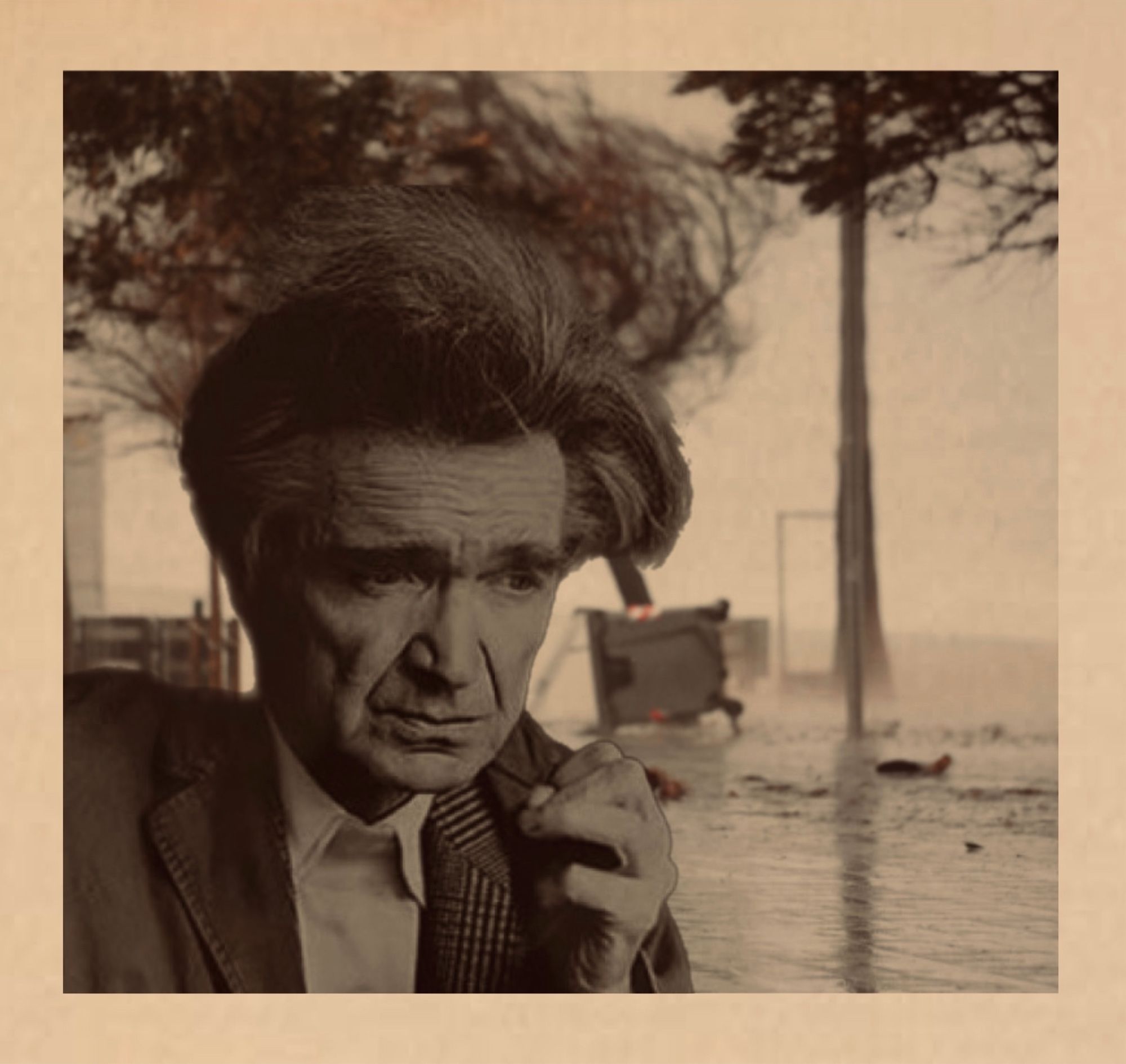 Cioran au premier plan ; à l’arrière-plan, de l’eau se déverse sur la route, un arbre qui se penche sous le vent, une poubelle renversée.