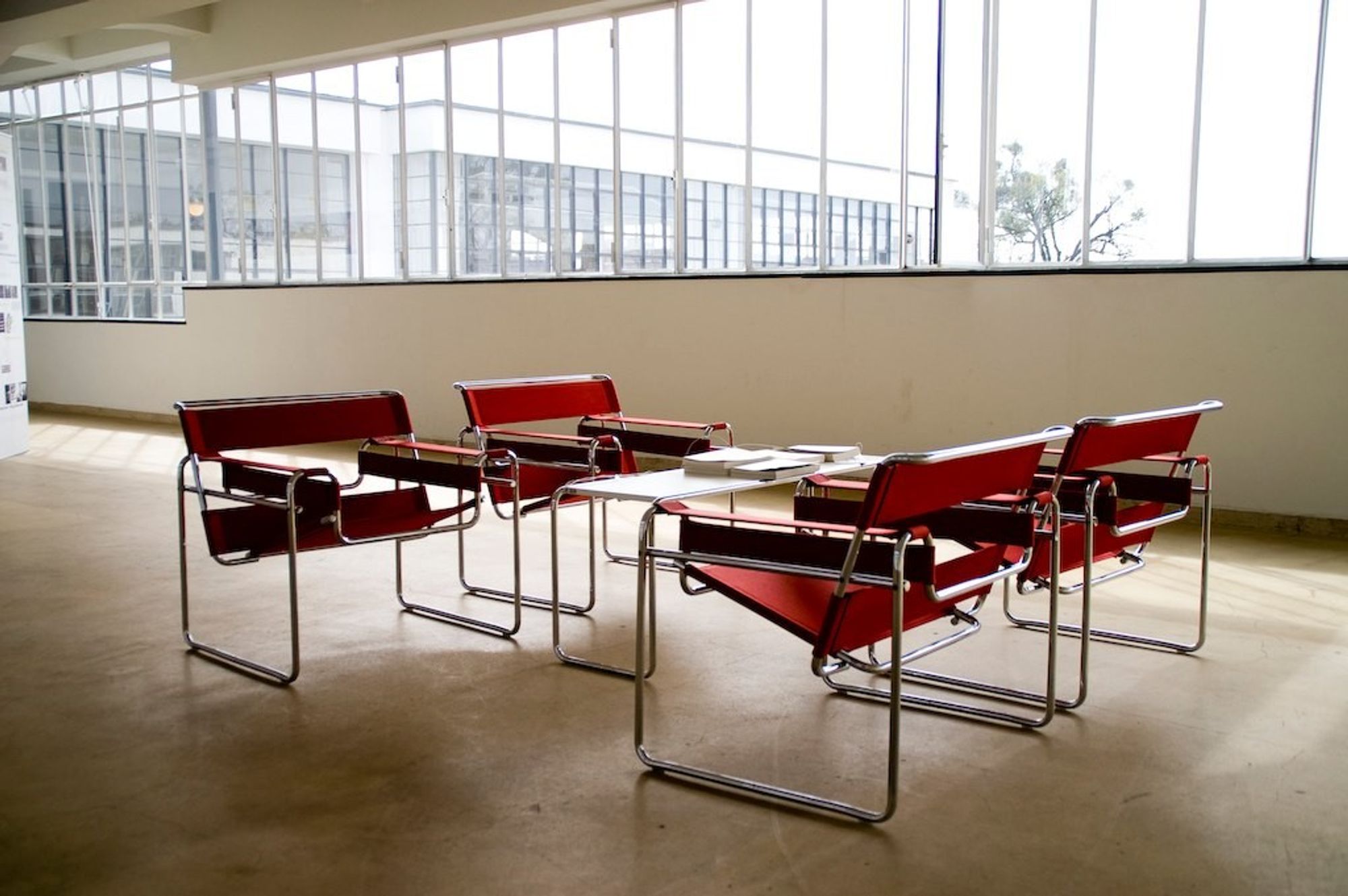 A tubular steel framed  table with four tubular steel and fabric chairs. 