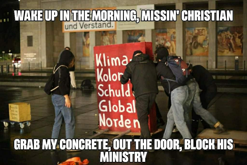 A groups of people are dragging a huge block. On the block is the message 
Climate and colonial debt of the global north
Grafic Text: wake up in the morning, missin' Christian. Grab my concrete, out the door, block his ministry