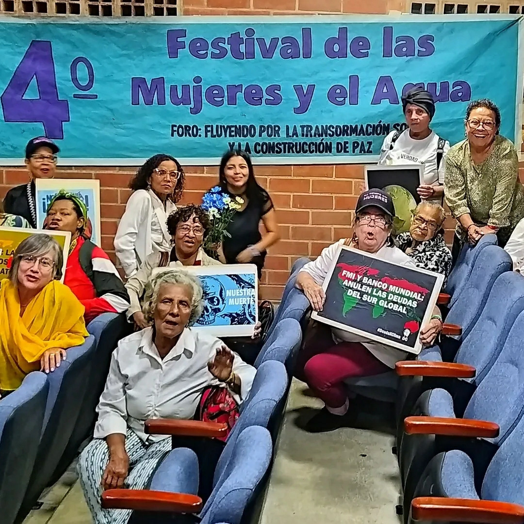 Women who met for a Festival for water and women. They have placards.
IMF and world bank, cancel the debt of the global south.