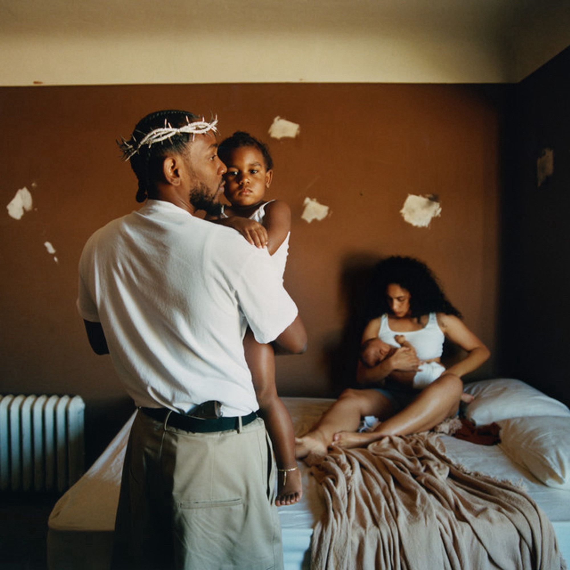 The cover to Mr. Morale & the Big Steppers. Kendrick with a crown of thorns holds one of his kids while long-time partner Whitney cradles or feeds the other in the background. They are in a bedroom with scuffed walls. 

This is the 342nd album to be added to the list.