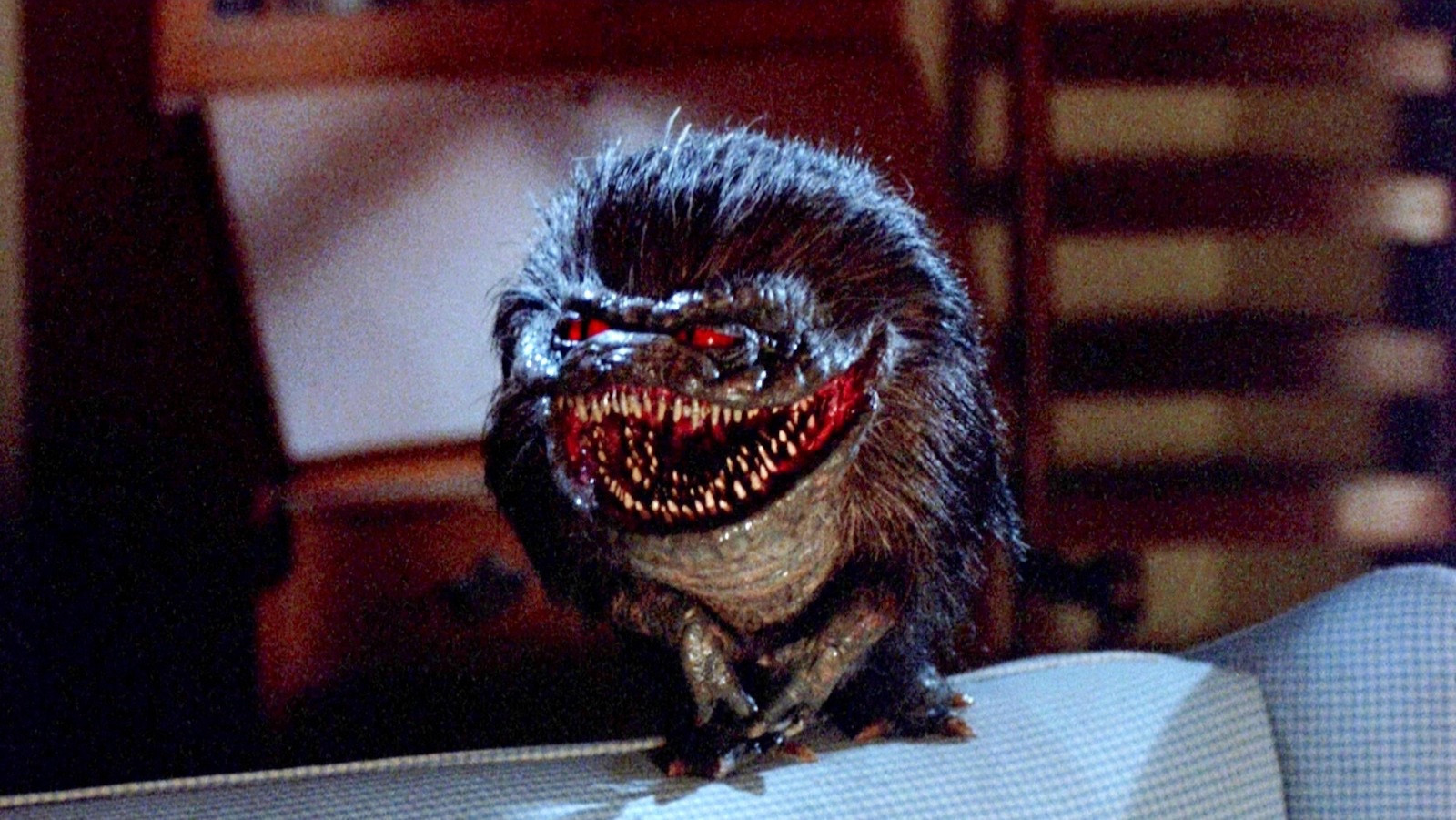 A crite from the movie critters. A small ball of fur with red eyes and an enormous grinning mouth with three rows of teeth