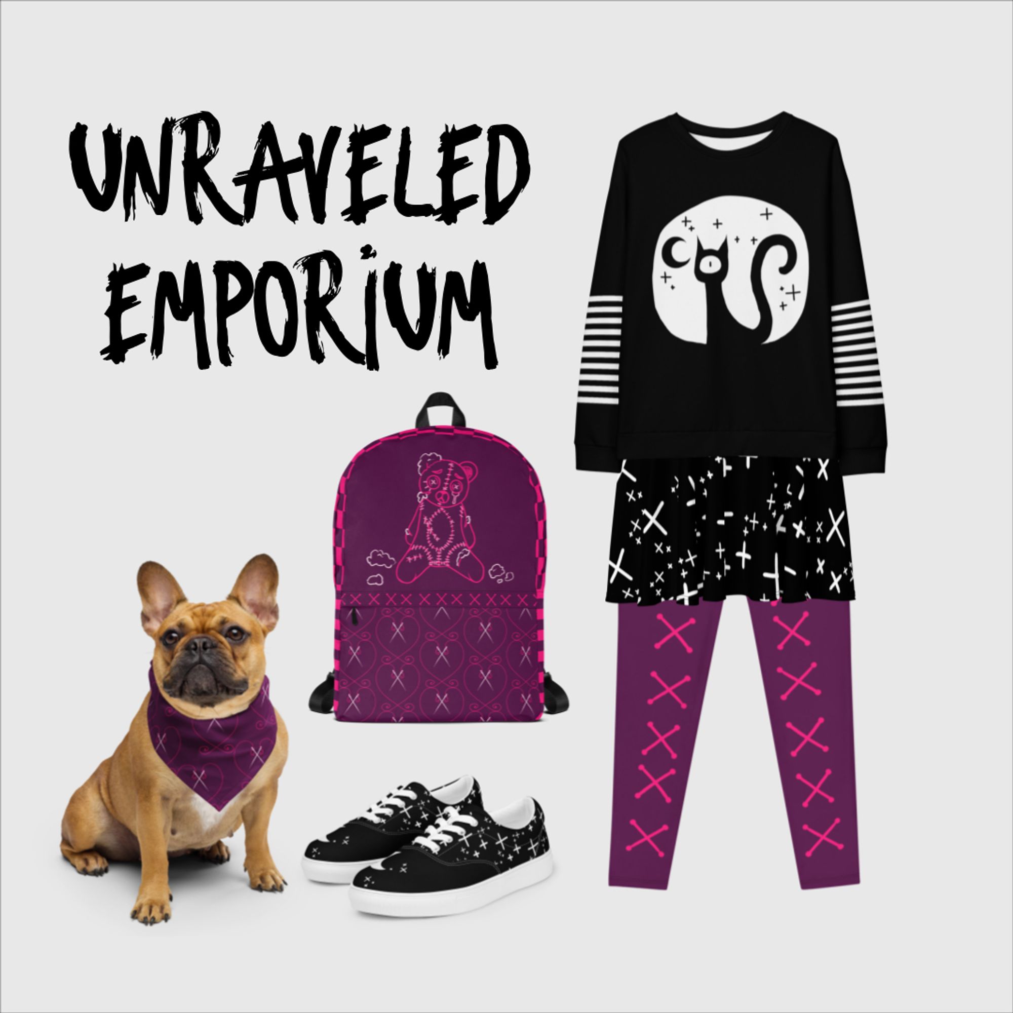 Clothing items and a brown dog wearing a purple/pink bandana. The clothing items are a backpack and leggings in purple and pink with a stitched bear motif and a sweatshirt, shoes and skirt in black and white with a one eye'd cat motif.