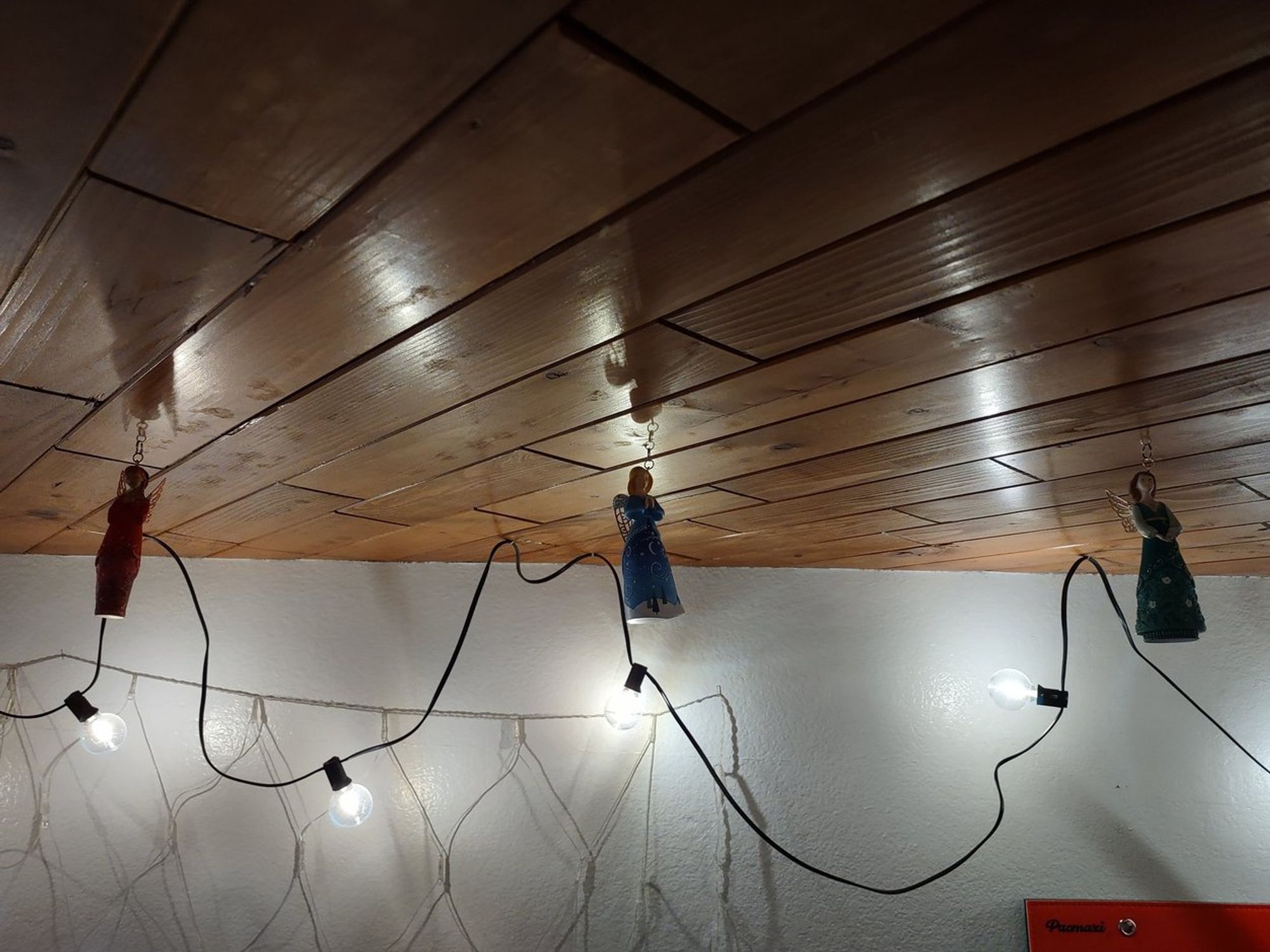 Bedroom ceiling, with hallmark angel ornaments hanging from it. One looks like Din, one looks like Nayru, one looks like Farore.