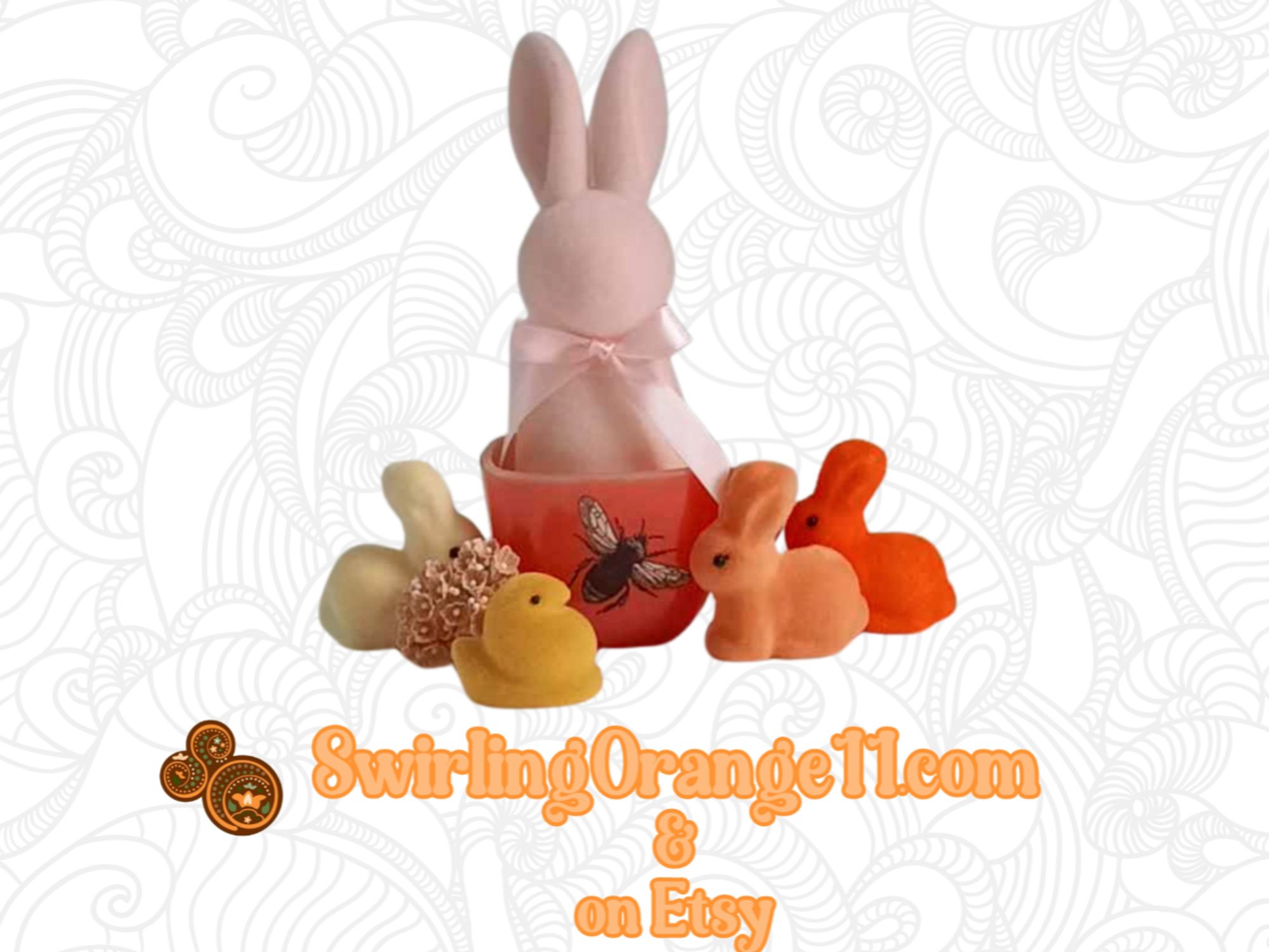 A pastel flocked bunny sitting in a Mid-Century Lipton Soup Promotional Mug in a bloodorange red color tattooed with a bumblebee and mini flocked bunnies and peep figurine.