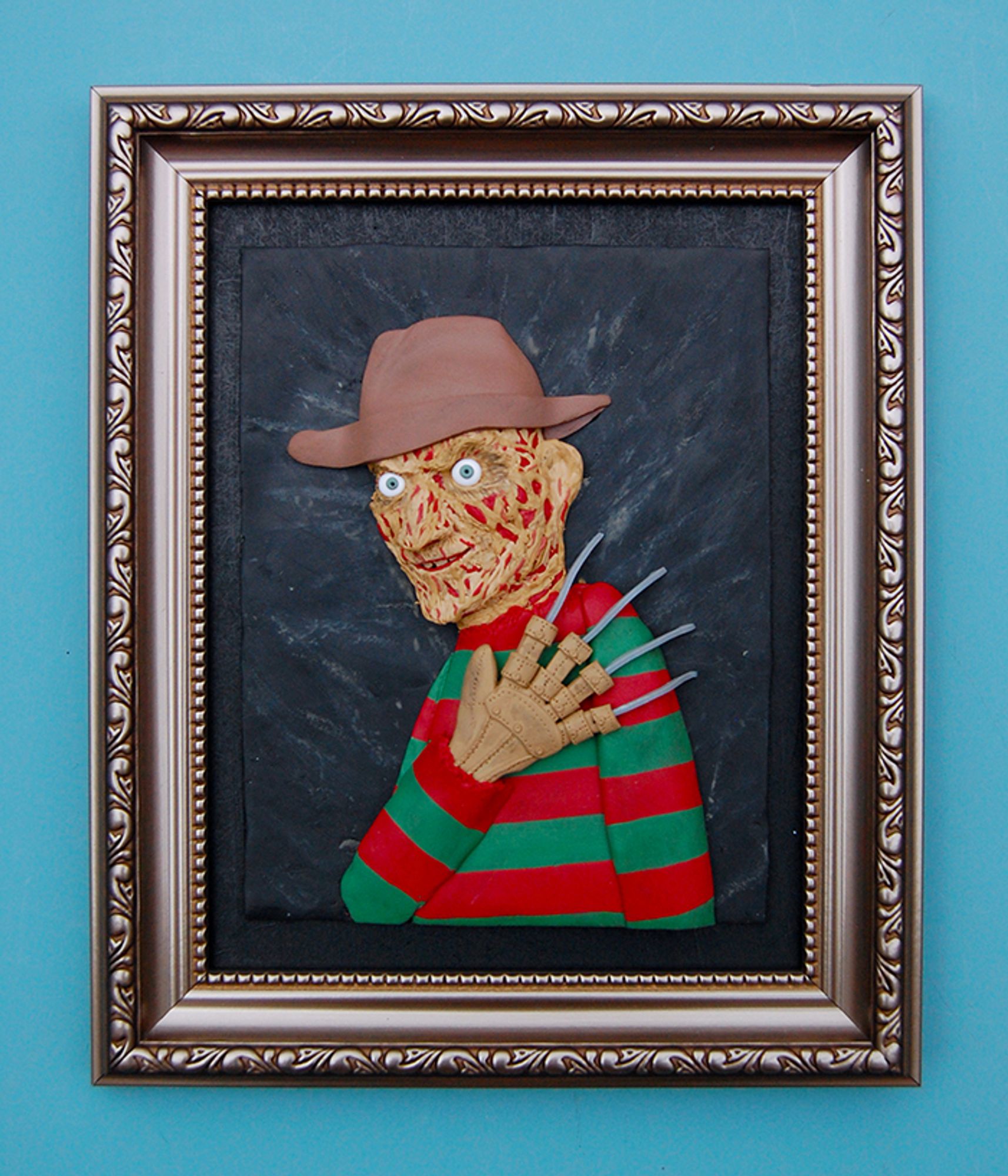 My polymer clay painting of Freddy Krueger in a shabby frame