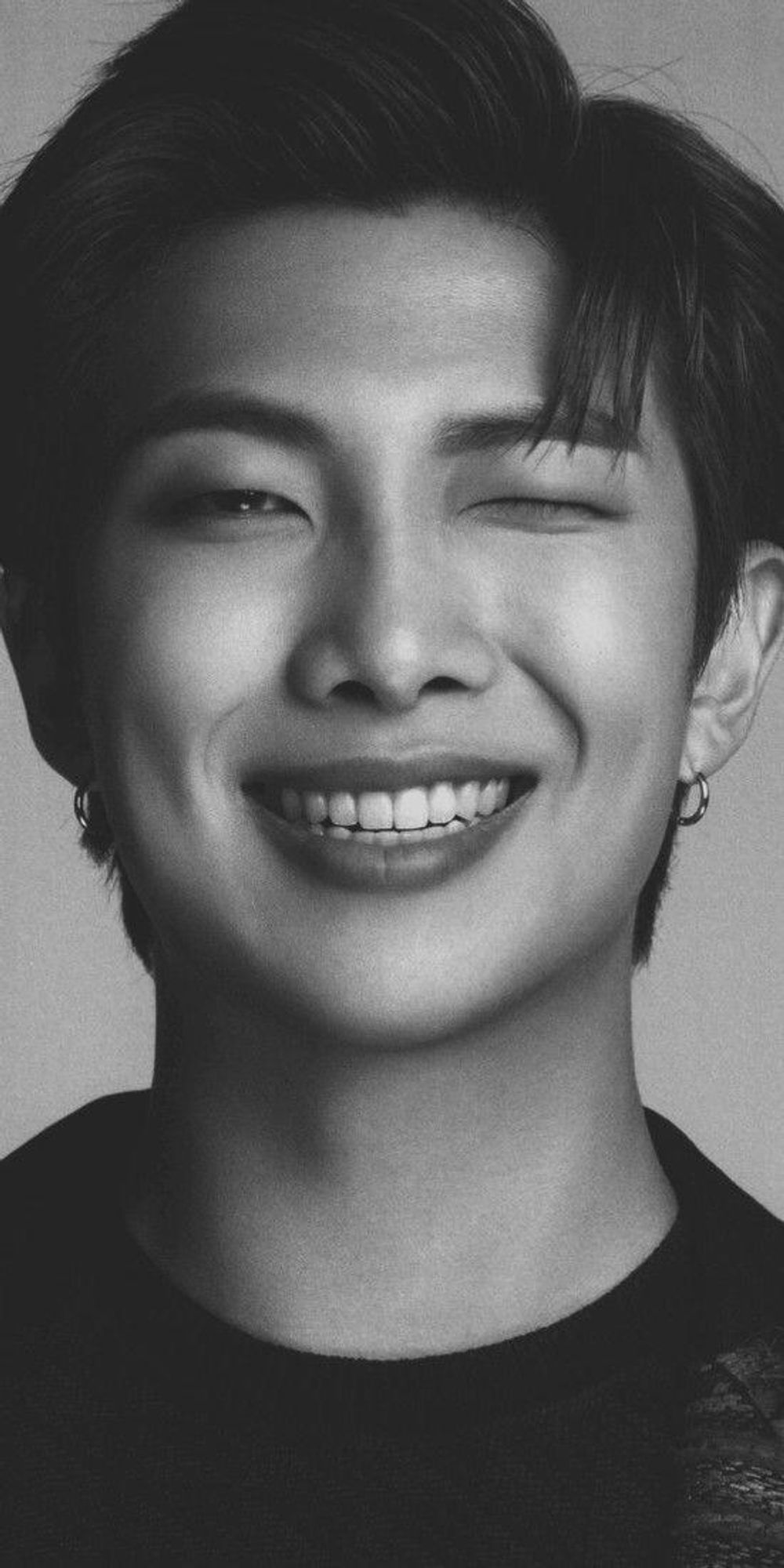 full face picture of Kim Namjoon leader of BTS smile & wink