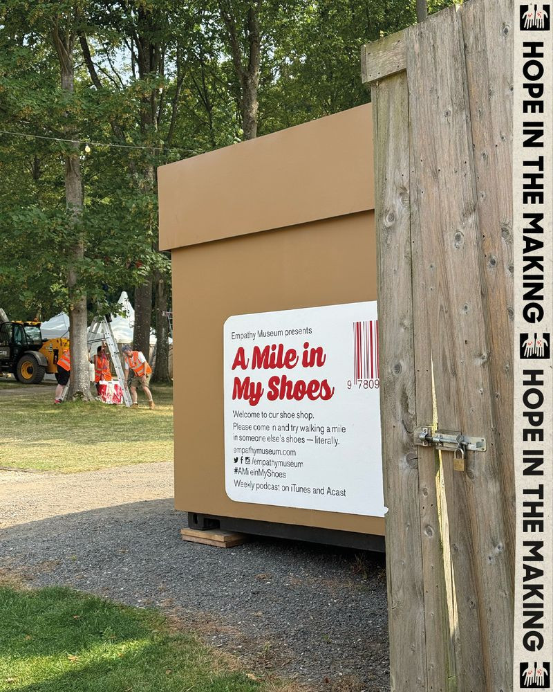 Sign for the Empathy Museum's exhibit "A Mile in My Shoes," inviting visitors to experience walking in someone else's shoes.