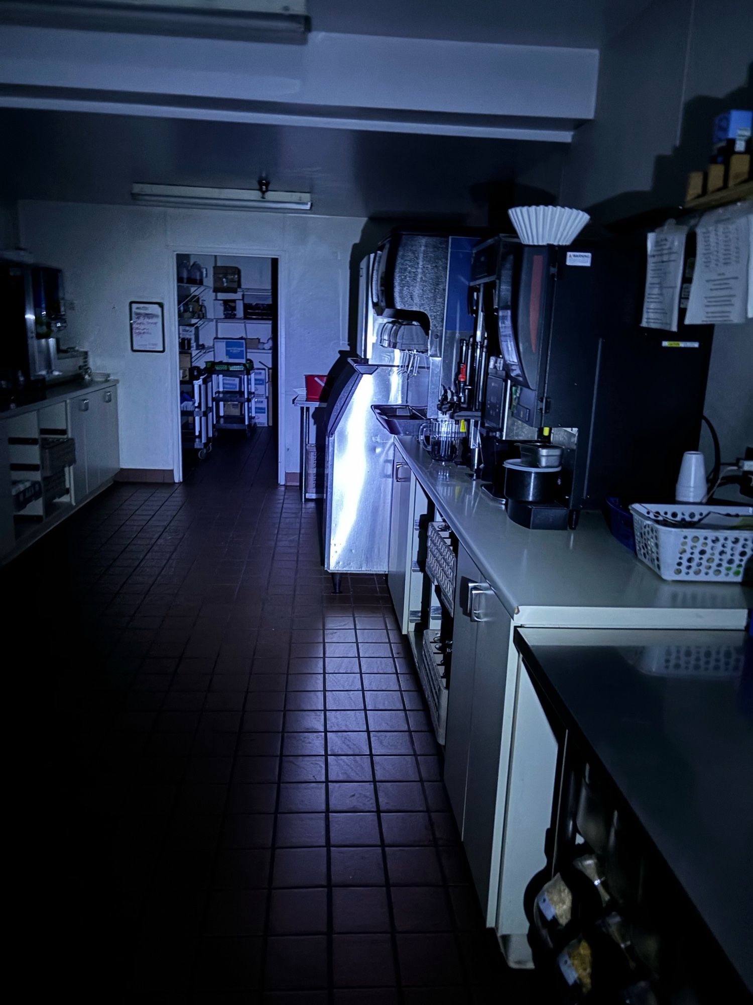 A kitchen area, lit via flashlight