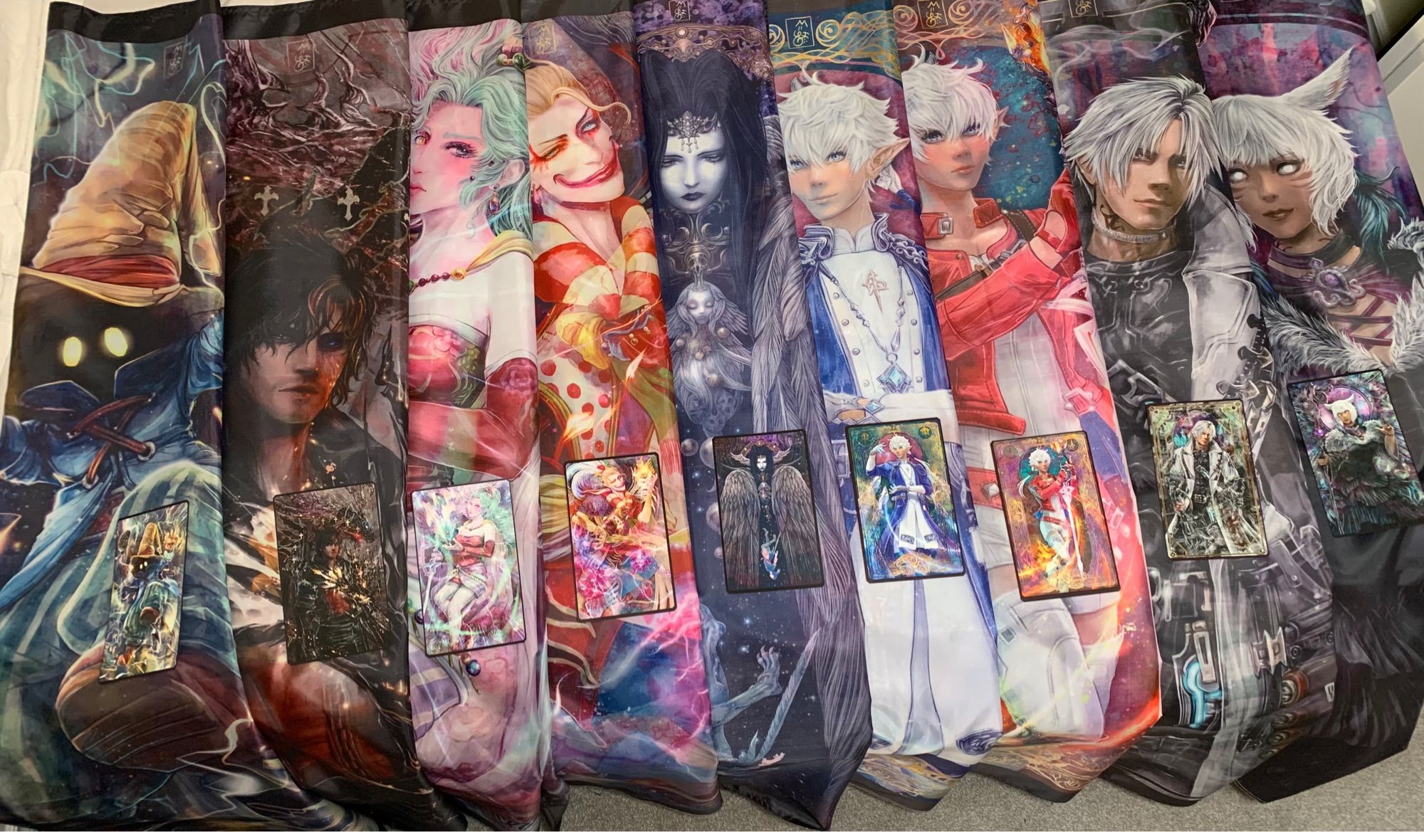 A spread of folded tapestries showing off various Final Fantasy characters along with their corresponding print