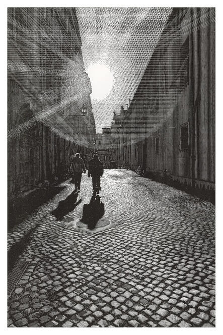 Two figures walking down a cobbled street into the distant shadows and sunrays