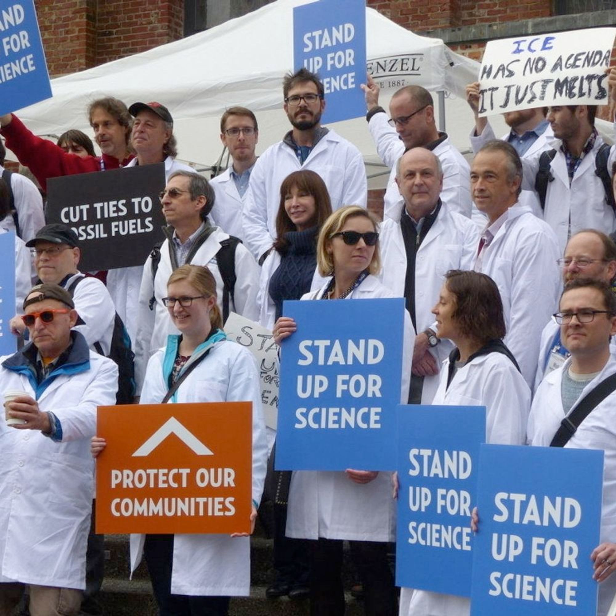 Real climate scientists holding up signs saying "stand up for science"