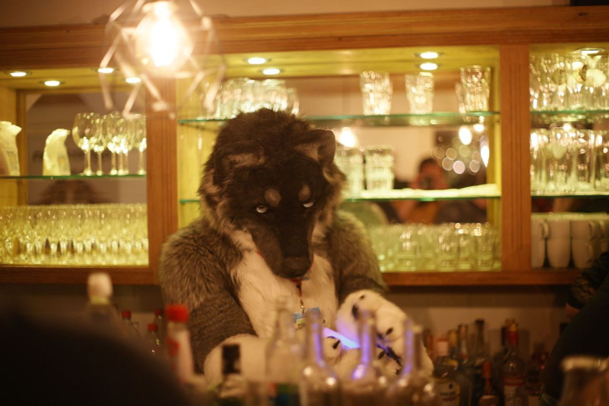 A Fursuiter Standing behind a Bar and preparing some drinks