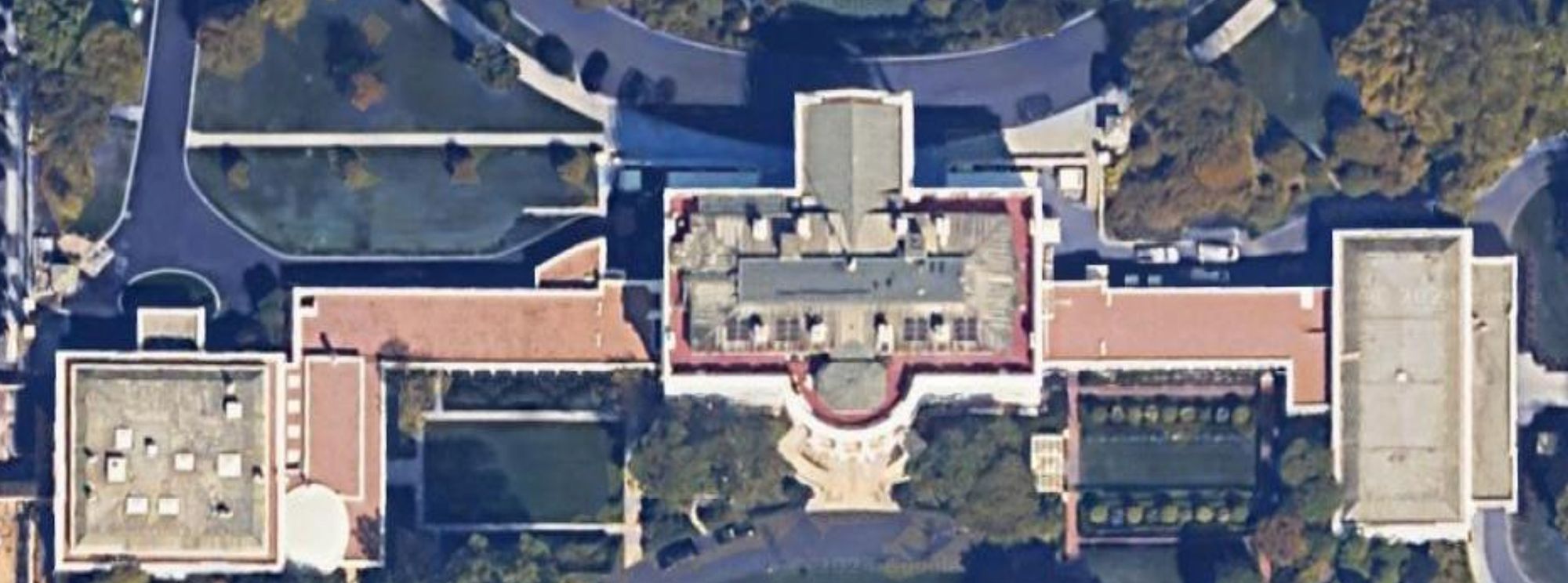 Satellite image of the roof of the White House. A few solar panels are sorta visible in the center.