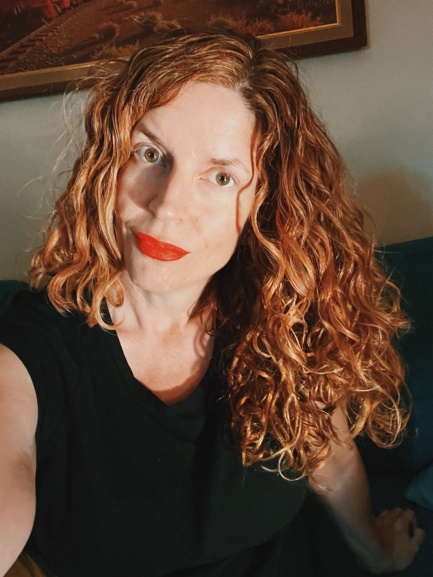 Jendia Gammon in a black t-shirt with late afternoon sunlight hitting messy wavy hair.