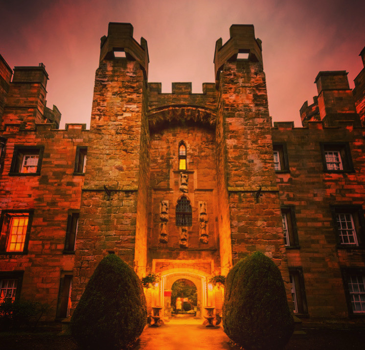 Lumley Castle, home of D&D in a Castle, lit up at night 