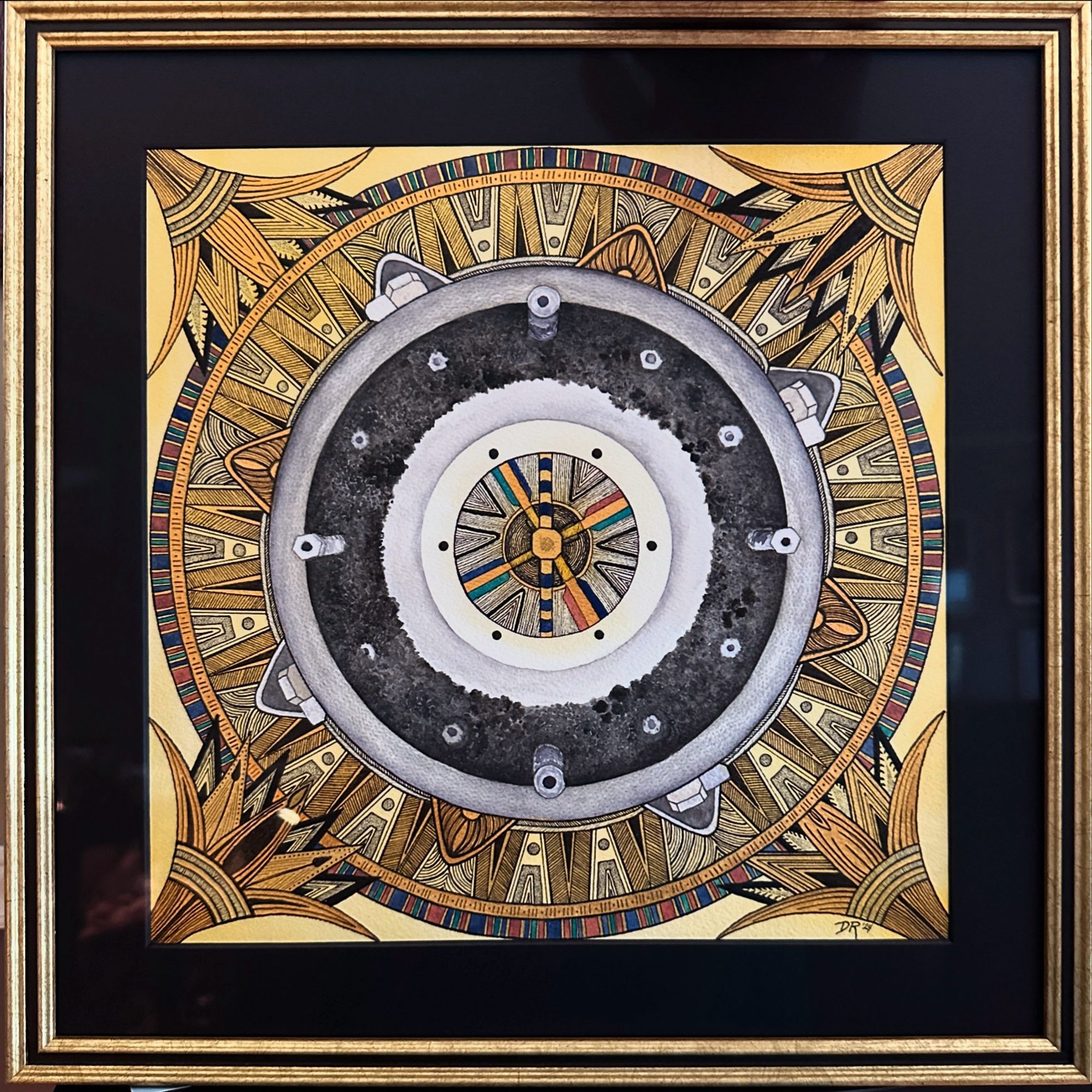 A framed painting of the top-down view of the opened sample return capsule from the OSIRIS-REx mission to asteroid Bennu. The frame is gold wood with a center stripe of black, with a black mat. Circular sections and hexagonal bolts are seen among the rocky material in the middle ring, framed by lotus flower motifs and patterned circles with geometric ink designs drawn in an ancient Egyptian style with gold accents. A ring of painted turquoise, lapis and carnelian rectangles accented with gold surrounds the inkwork. Inspired by the decorative motifs of Tutankhamen’s treasures, and the Art Deco-tinged Egyptian Revival movement that arose from the discovery of said treasures.