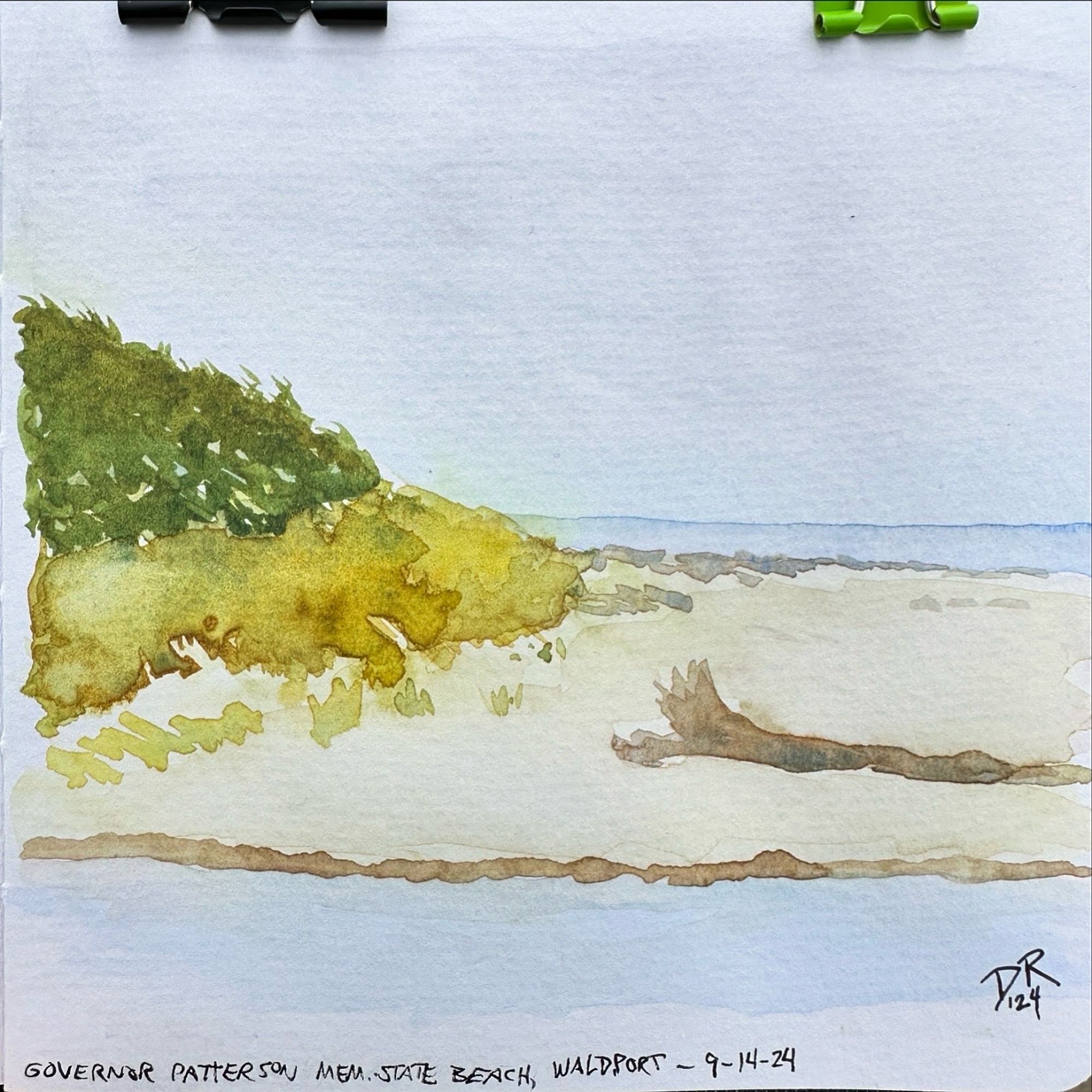 A watercolor painting on toned gray paper of a green forested hills sloping down into yellow-green beach grasses and a driftwood-laden sand beach, with the ocean along the horizon to the right and a steam of fresh water along the foreground. The skies are light but overcast.