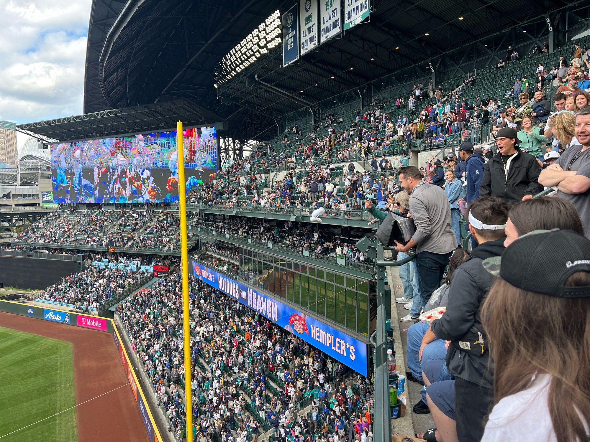 Hotdog being thrown from the 300 level down to the people below.