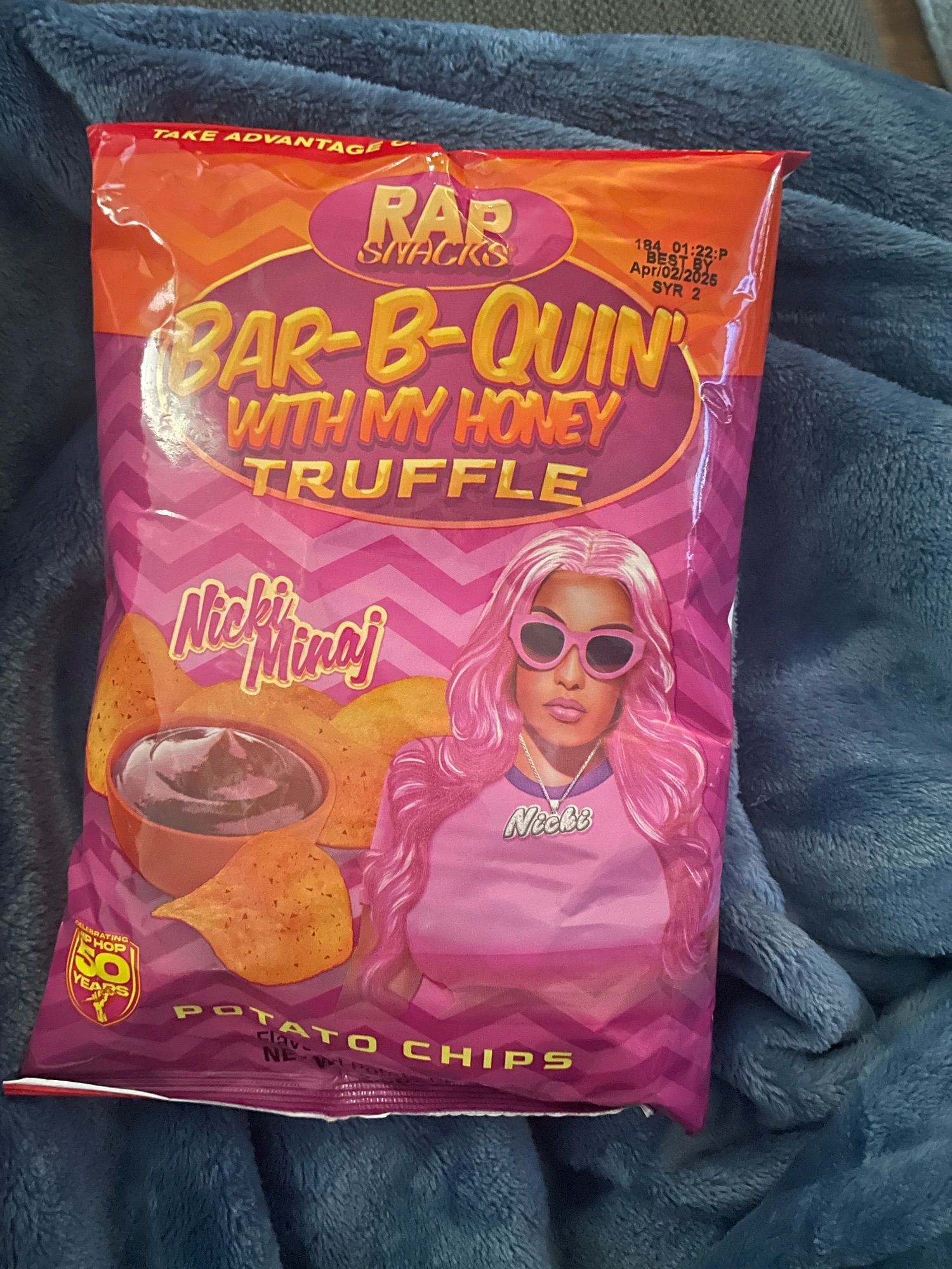 Front of crisp packet with pocture of Nicki Minaj with pink hair on pink and orage background