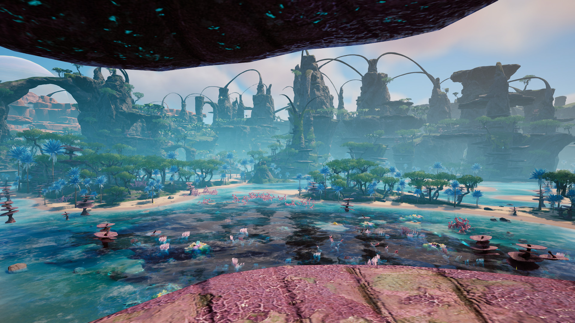 View of the alien landscape in videogame Satisfactory, spindly mountainous cliffs in the background, and a coastal beach area in the foreground.