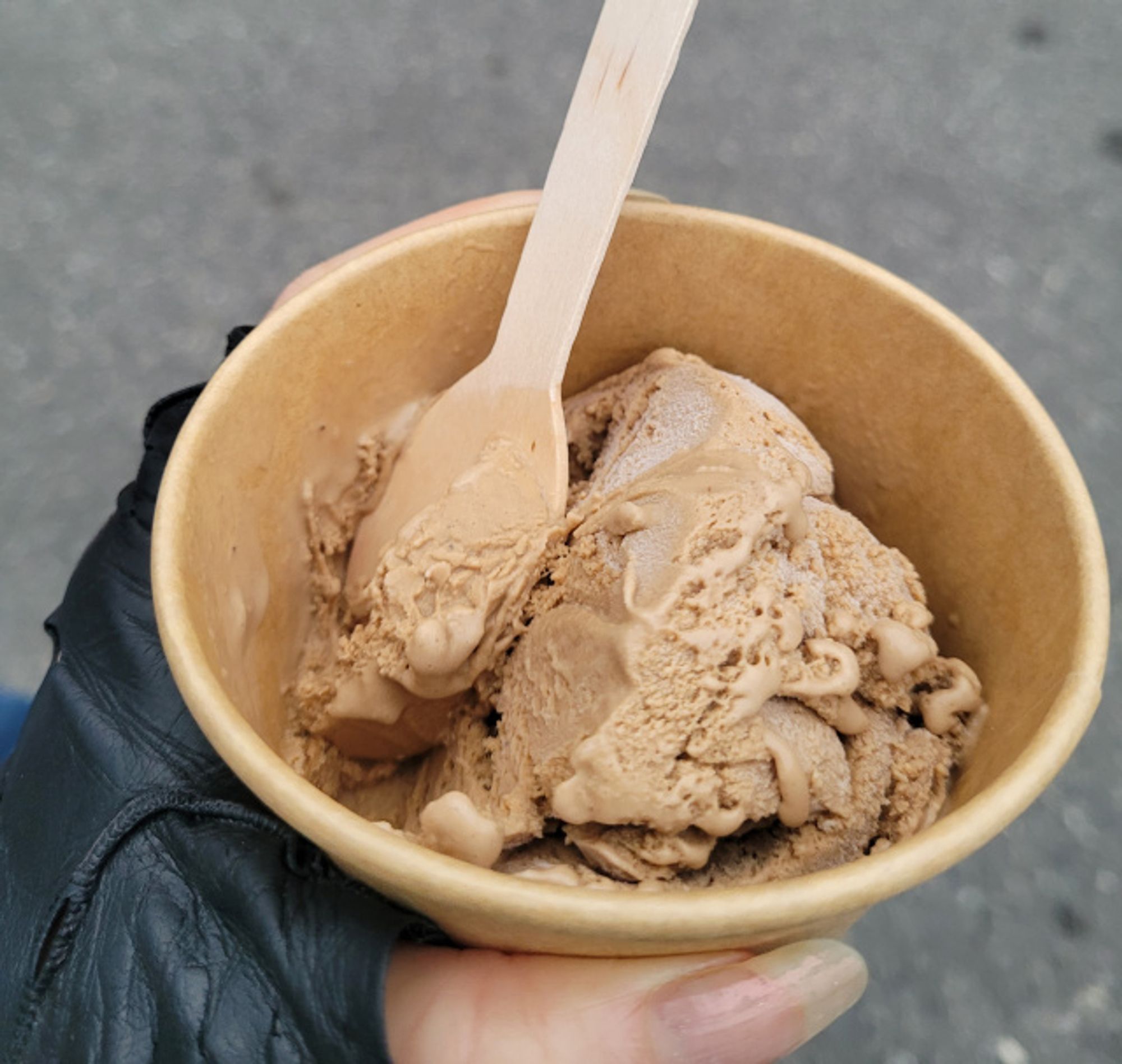 Hand holding a (half eaten lol) cup of HK milk tea ice cream from Good Behaviour