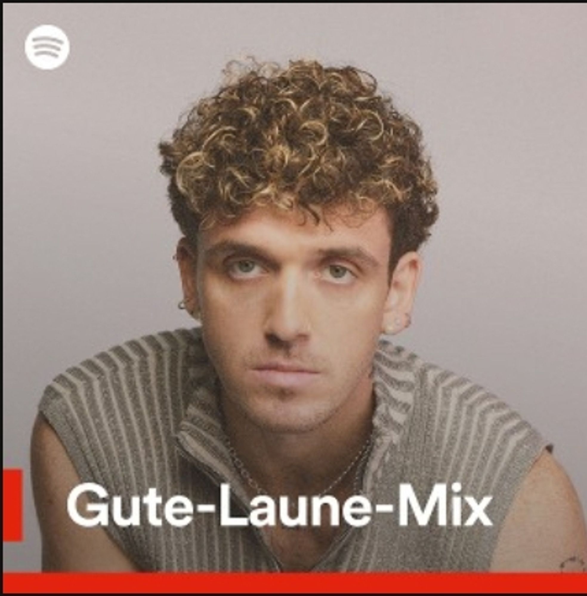 Spotify Playlist Vorschlag namens Gute-Laune-Mix mit einem sehr schlecht gelaunt guckenden Musiker als Bild.