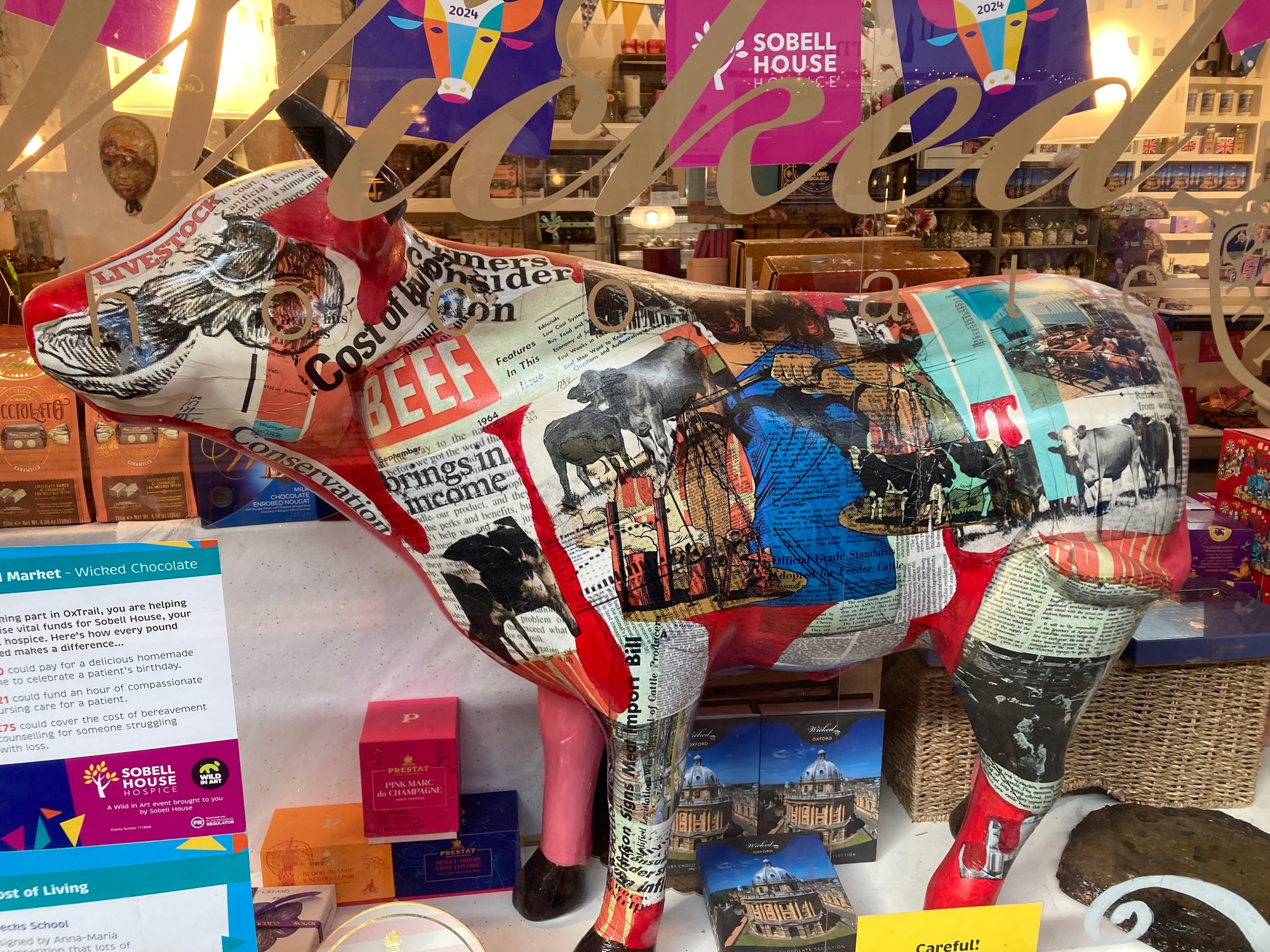 small ox sculpture decorated to look like it’s covered in newspaper cuttings