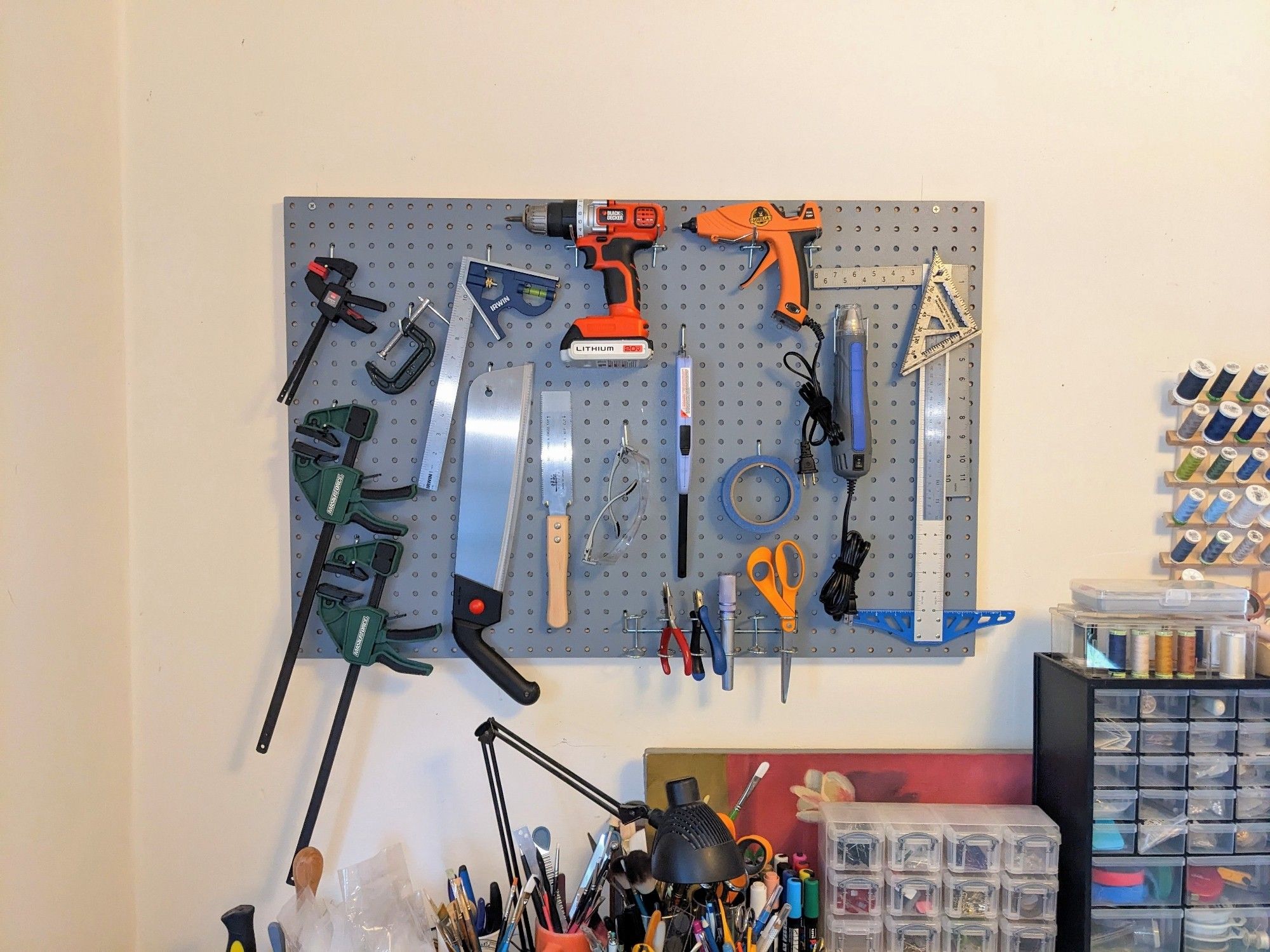 Photo of the same pegboard filled with a variety of tools and useful items.