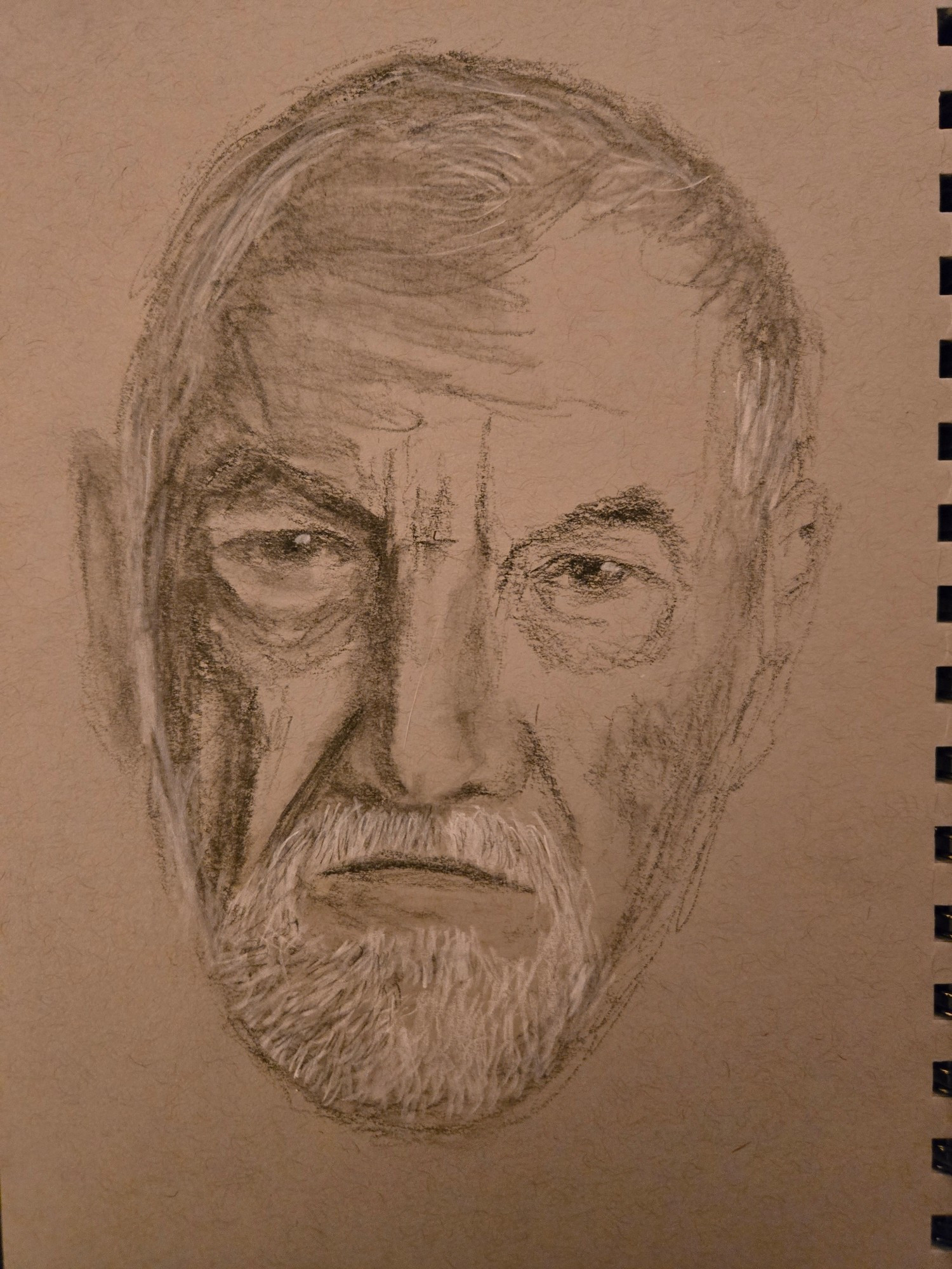 Charcoal and white chalk drawing of an old man's face