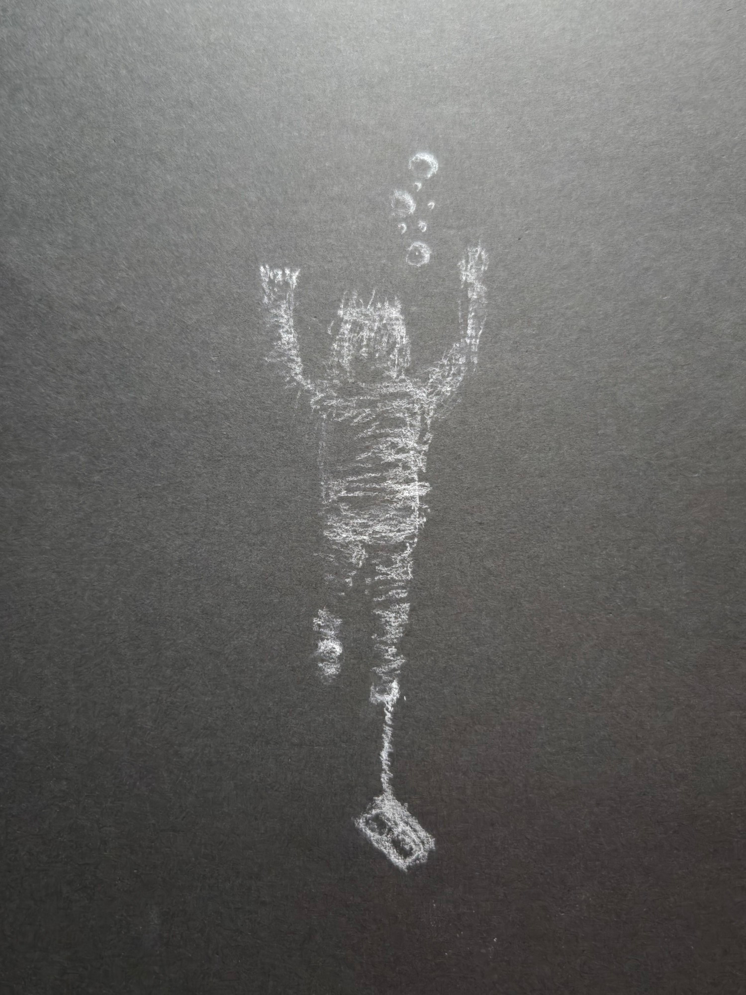 White chalk drawing of a person being pulled underwater by a cinder block tied to their ankle. Bubbles are floating up