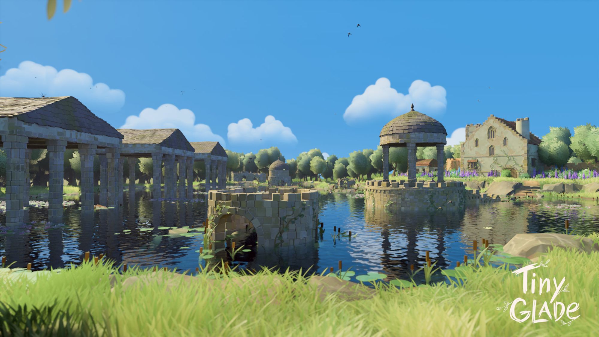 A screenshot from Tiny Glade. Stone ruins of broken towers, Greek-style temples, and a gazebo are flooded by a small lake. In the background is an aged but more modern mansion.