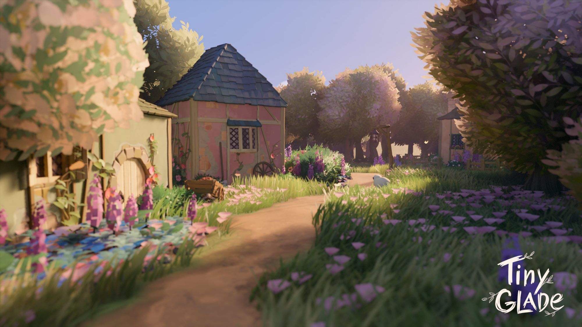 A screenshot of a build from Tiny Glade. A series of small wooden cottages in pink, green, and blue alongside a path that cuts through flower-filled fields