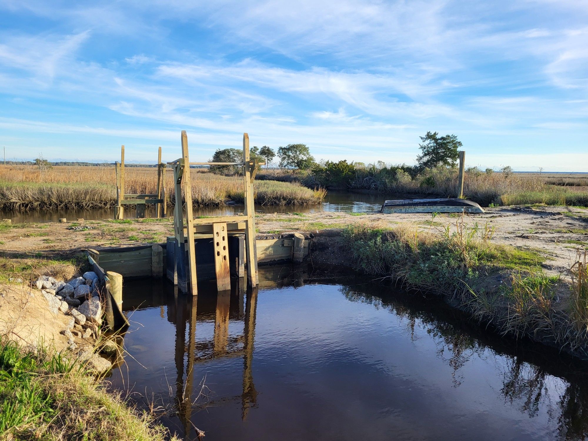 Wooden water control feature that is used to manage water levels in wetlands, photo taken in coastal South Carolina in winter 2023