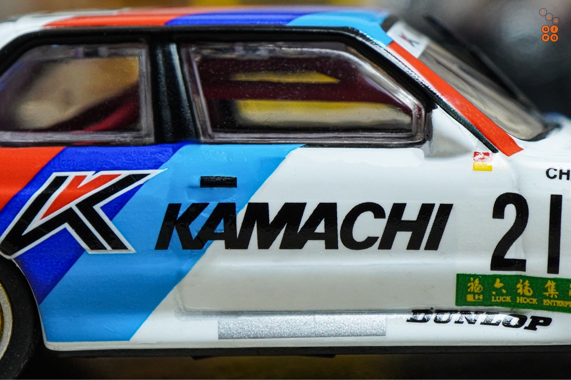 A close-up shot of BMW E30 M3, Kamachi racing livery by Tarmac Works in 1:64 scale  on AREA 164