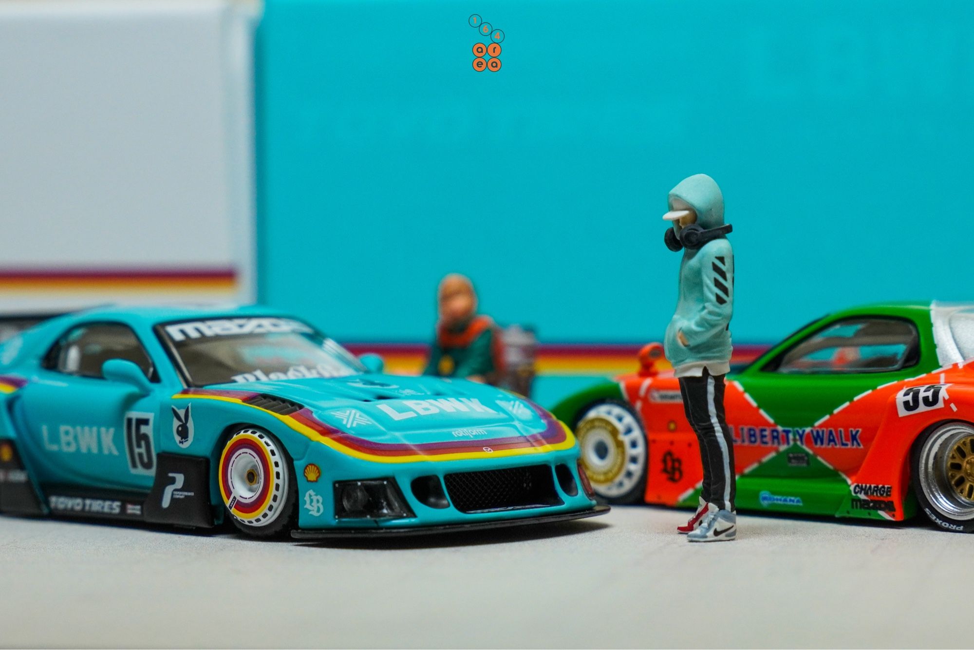 Mazda RX-7 FD3S, LB-Super Silhouette, Hobby Expo China 2024 Edition beside a Renown livery, both by iNNO64 in 1:64 scale with 1:64 figure on AREA 164