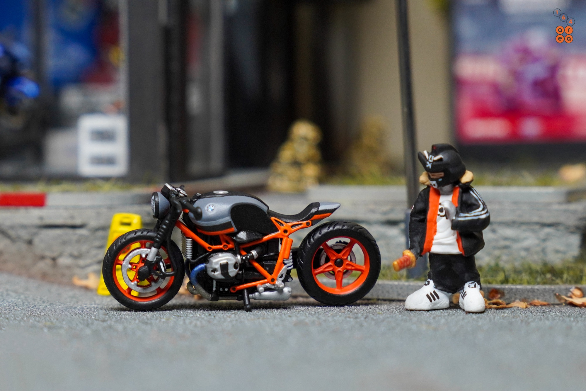 BMW R nineT in grey with orange accent in 1:64 scale with 1:64 figure on AREA 164