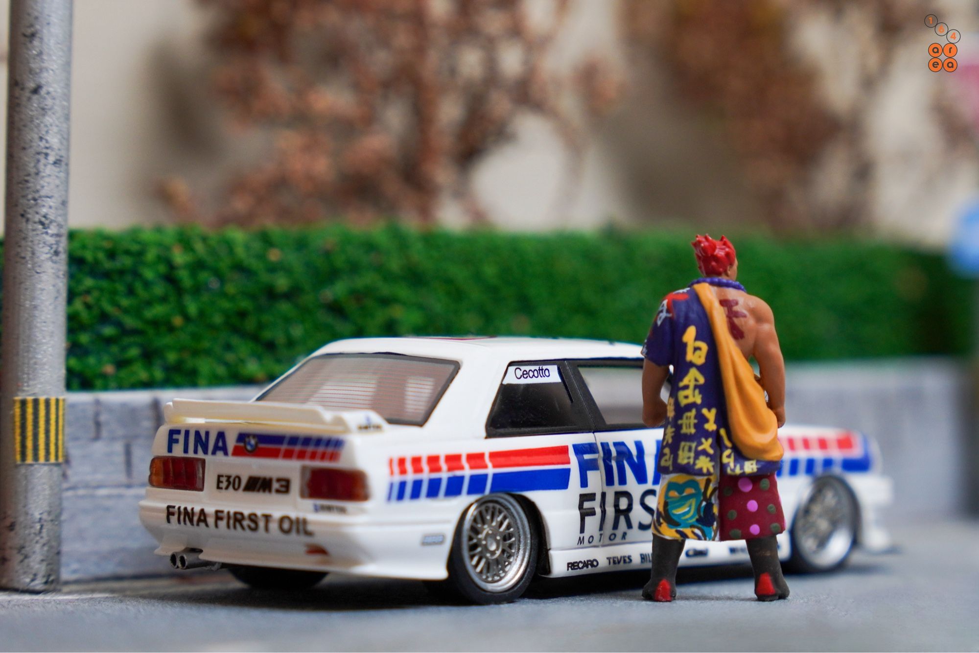 A big guy and BMW E30 M3, FINA First Oil livery by ScaleMini in 1:64 scale with 1:64 figure on AREA 164