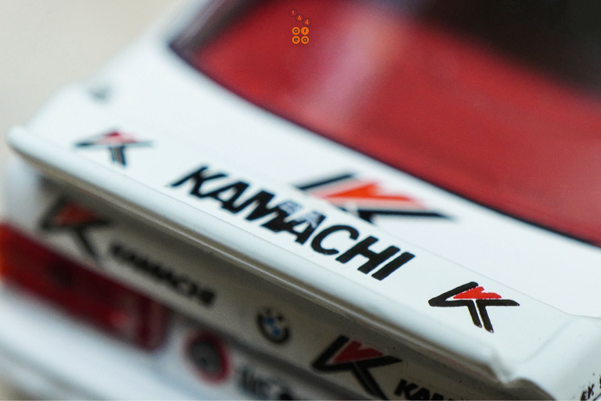 A close-up shot of BMW E30 M3, Kamachi racing livery by Tarmac Works in 1:64 scale  on AREA 164