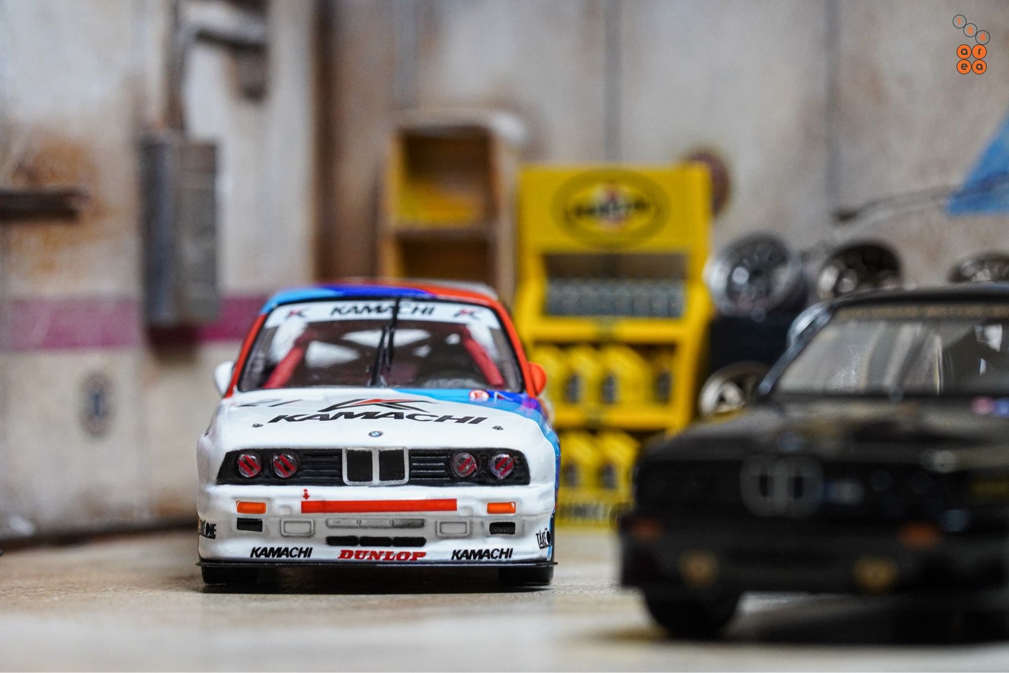 A BMW E30 M3, Kamachi racing livery by Tarmac Works in 1:64 scale on AREA 164