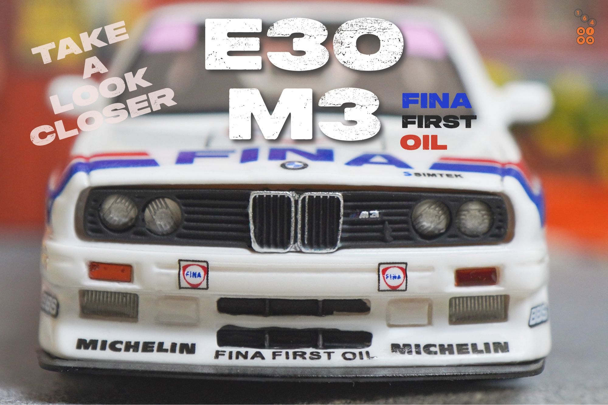 A close-up shot of BMW E30 M3, FINA First Oil livery by ScaleMini in 1:64 scale on AREA 164