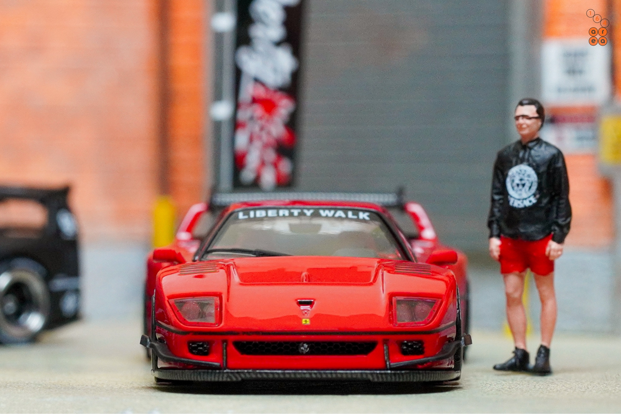 A front side of a red LB-WORKS Ferrari F40 by INNO64 in 1:64 scale on AREA 164