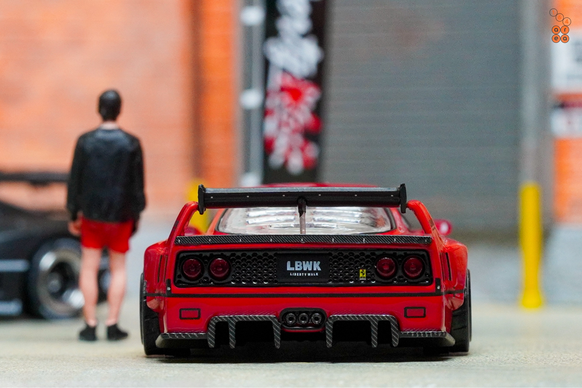 A rear side of a red LB-WORKS Ferrari F40 by INNO64 in 1:64 scale on AREA 164