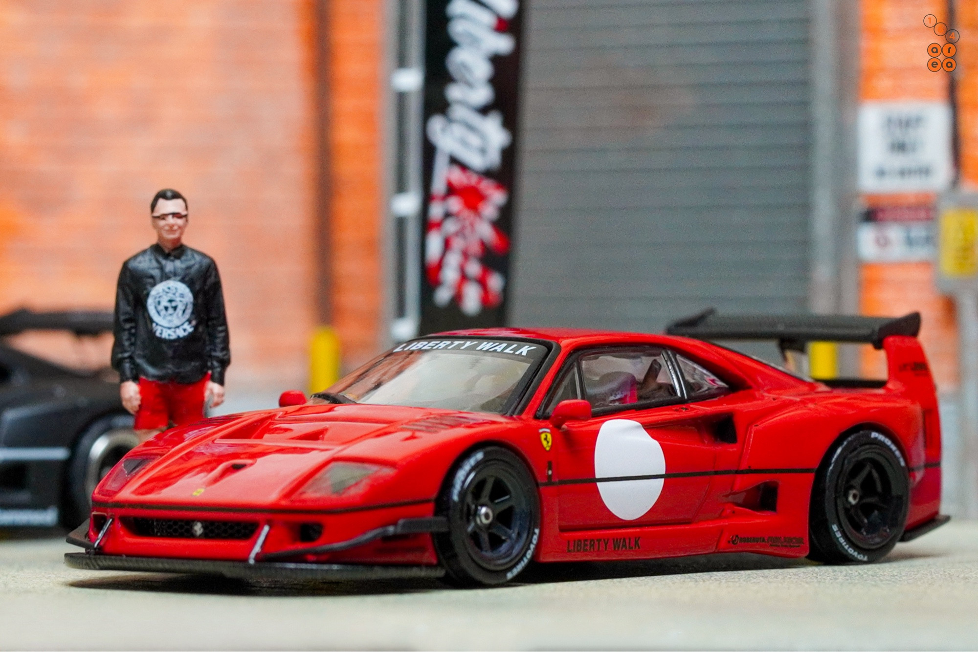 A left side of a red LB-WORKS Ferrari F40 by INNO64 in 1:64 scale on AREA 164