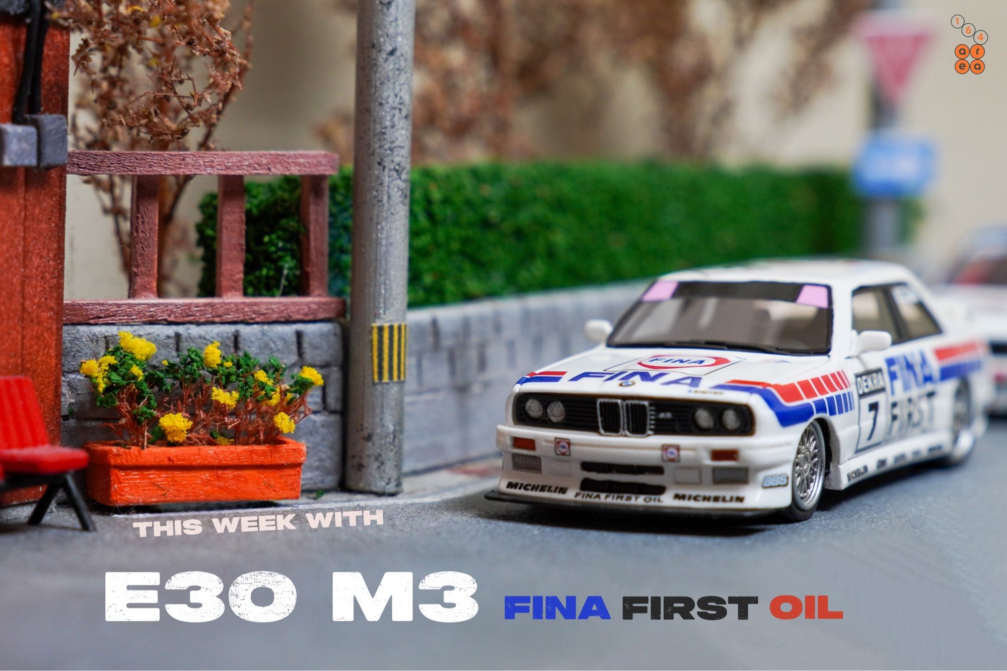 A BMW E30 M3, FINA First Oil livery by ScaleMini in 1:64 scale with 1:64 figures on AREA 164